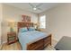 Bedroom with a rustic queen-size bed, wooden nightstands, and ceiling fan at 350 River Enclave Ct, Bradenton, FL 34212