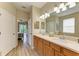 Double vanity bathroom with wood cabinets and access to bedroom and shower at 350 River Enclave Ct, Bradenton, FL 34212