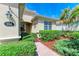 Landscaped entryway with a brick walkway leading to the front door at 350 River Enclave Ct, Bradenton, FL 34212