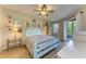 Cozy bedroom with light blue bed frame, striped bedding, and access to a patio at 350 River Enclave Ct, Bradenton, FL 34212