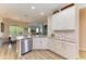 Open concept kitchen with granite countertops, white cabinets, and a breakfast bar at 350 River Enclave Ct, Bradenton, FL 34212