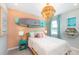 Bedroom with coral accent wall, a paddleboard display, and coastal decor at 15076 Shady Palms Ln, Nokomis, FL 34275