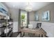 Home office with built-in shelving, a large desk, and plenty of natural light at 15076 Shady Palms Ln, Nokomis, FL 34275