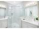 Double vanity bathroom with a large, frameless shower at 15076 Shady Palms Ln, Nokomis, FL 34275