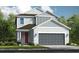 Two-story home with gray siding, red door, and a gray two-car garage at 15076 Shady Palms Ln, Nokomis, FL 34275