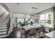 Open concept dining room with a large table, chandelier, and hardwood floors at 15076 Shady Palms Ln, Nokomis, FL 34275