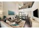 Two story living room with vaulted ceiling, comfortable seating, and open floor plan at 15076 Shady Palms Ln, Nokomis, FL 34275