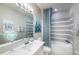 Bathroom with white vanity, gray tile shower, and teal accents at 15076 Shady Palms Ln, Nokomis, FL 34275