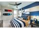 Guest bedroom with a bed, wall-mounted surfboards, and nautical theme at 15076 Shady Palms Ln, Nokomis, FL 34275
