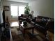 Living room with brown couches and wood flooring at 7365 Black Walnut Way, Lakewood Ranch, FL 34202