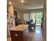 Kitchen with island, dining area, and access to balcony at 7365 Black Walnut Way, Lakewood Ranch, FL 34202
