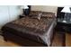 Bedroom with a double bed and patterned bedding at 7365 Black Walnut Way, Lakewood Ranch, FL 34202