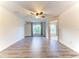 Spacious bedroom with wood-look floors, window, and access to bathroom at 4005 Belladonna Ave, North Port, FL 34286