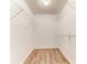 Walk-in closet with wire shelving and wood-look flooring at 4005 Belladonna Ave, North Port, FL 34286