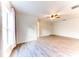 Bright bedroom with wood-look floors, large window, and ceiling fan at 4005 Belladonna Ave, North Port, FL 34286