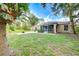 Large backyard with patio, fire pit, and lush lawn at 4005 Belladonna Ave, North Port, FL 34286