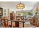 Dining area with a wooden table, chairs, and a view of the living room and kitchen at 4956 Stevens Dr, Sarasota, FL 34234