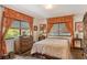 Cozy bedroom with antique furniture and large windows at 4956 Stevens Dr, Sarasota, FL 34234