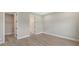 Bedroom with gray walls, wood-look tile flooring, and a walk-in closet at 14551 Skipping Stone Loop, Parrish, FL 34219