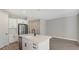 Open kitchen with island, white cabinets, quartz countertops and stainless steel appliances at 14551 Skipping Stone Loop, Parrish, FL 34219