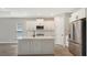 Island kitchen with white cabinets and quartz countertop at 14551 Skipping Stone Loop, Parrish, FL 34219