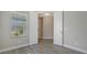 Well-lit bedroom with wood-look tile flooring and double doors at 14551 Skipping Stone Loop, Parrish, FL 34219
