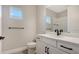 Clean bathroom with white vanity, black fixtures, and tile floor at 14551 Skipping Stone Loop, Parrish, FL 34219
