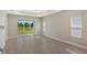 Bright living area with tile flooring and sliding glass doors leading to a patio at 14551 Skipping Stone Loop, Parrish, FL 34219
