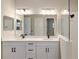 Bathroom with double vanity, quartz countertops and a large shower at 14551 Skipping Stone Loop, Parrish, FL 34219