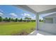 View of backyard, grassy lawn, and hedgerow at 14551 Skipping Stone Loop, Parrish, FL 34219