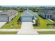 Newly built home with light blue exterior and two-car garage at 14551 Skipping Stone Loop, Parrish, FL 34219