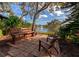 Relaxing patio area with wooden seating overlooking pond at 19505 Quesada Ave # B204, Port Charlotte, FL 33948