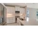 Modern kitchen with white cabinets, stainless steel appliances, and a large island at 14705 Barefoot Ln, Parrish, FL 34219