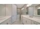 Elegant bathroom with double vanity, large mirror, and walk-in shower at 14705 Barefoot Ln, Parrish, FL 34219