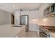 Modern kitchen featuring white cabinets, quartz countertops, and stainless steel appliances at 14705 Barefoot Ln, Parrish, FL 34219