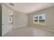 Bedroom with window, tile floors and view of hallway at 14705 Barefoot Ln, Parrish, FL 34219