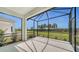 Spacious screened-in porch overlooking a lush backyard at 14705 Barefoot Ln, Parrish, FL 34219