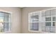 Bright room featuring two large windows with blinds at 14705 Barefoot Ln, Parrish, FL 34219