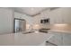 Modern kitchen featuring white cabinets, quartz countertops, and stainless steel appliances at 14705 Barefoot Ln, Parrish, FL 34219