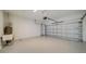 Garage with an overhead door and painted floor at 14705 Barefoot Ln, Parrish, FL 34219