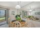 Dining area with round table and chairs, mirrored wall at 6157 Midnight Pass Rd # G11, Sarasota, FL 34242