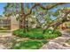 Lovely landscaped courtyard with mature oak trees and brick pathways at 6157 Midnight Pass Rd # G11, Sarasota, FL 34242