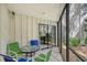 Enjoy your morning coffee on this screened patio with glass-top table and chairs at 6157 Midnight Pass Rd # G11, Sarasota, FL 34242