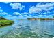 Stunning view of calm water, lush greenery, and waterfront homes at 6157 Midnight Pass Rd # G11, Sarasota, FL 34242