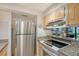 Kitchen with stainless steel appliances and light wood cabinets at 6157 Midnight Pass Rd # G11, Sarasota, FL 34242