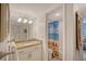 Full bathroom with tub shower, granite vanity, and beach-themed decor at 6157 Midnight Pass Rd # G11, Sarasota, FL 34242