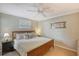 Spacious bedroom featuring a king-size bed and ceiling fan at 6157 Midnight Pass Rd # G11, Sarasota, FL 34242