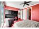 Bedroom with built-in desk, red walls, and access to a bathroom at 3576 Fair Oaks Way, Longboat Key, FL 34228