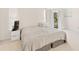 Main bedroom with a king-size bed, nightstand, and access to a balcony at 6515 Mauna Loa Blvd, Sarasota, FL 34241