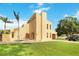 Two-story yellow house with a large yard, palm trees, and a detached garage at 6515 Mauna Loa Blvd, Sarasota, FL 34241